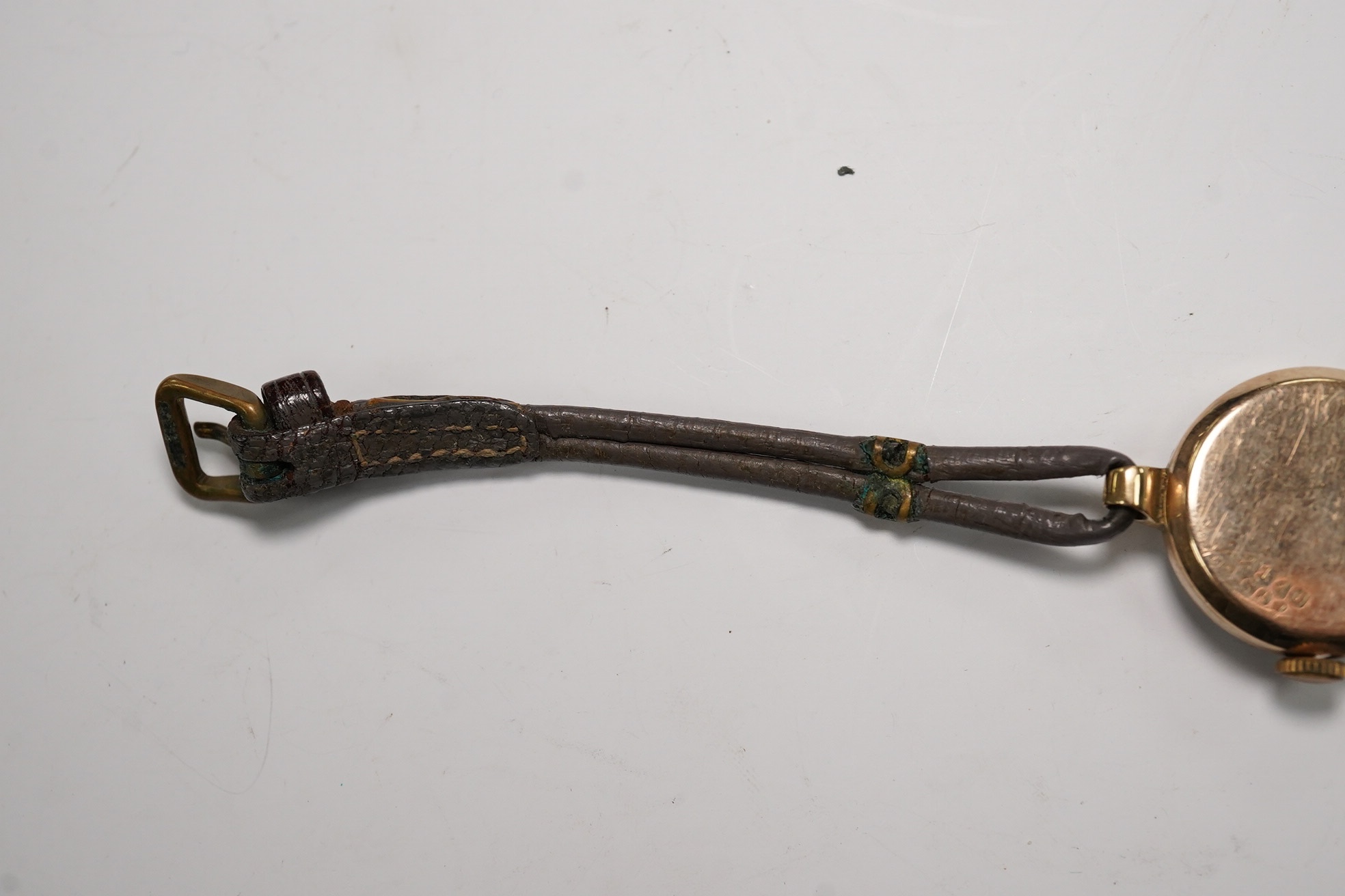 A lady's 9ct gold Rolex manual wind wrist watch, with Arabic dial and subsidiary seconds, case back numbered 22110, case diameter 21mm, on an associated twin strand fabric strap. Condition - poor to fair